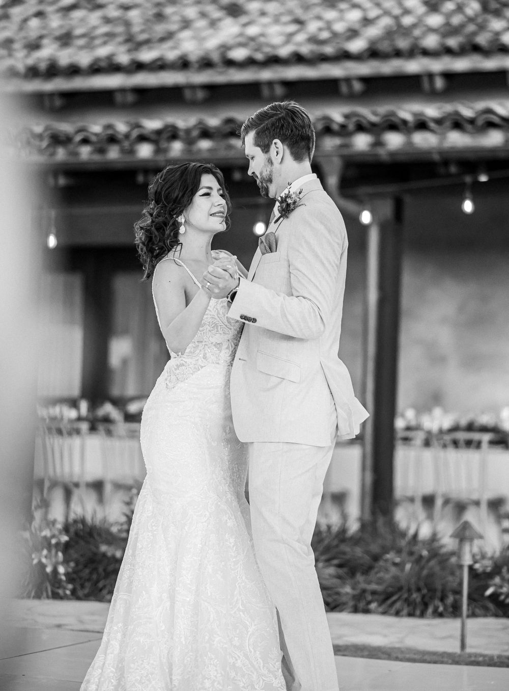 Elegant black and white portrait of a couple's first dance at their wedding reception.