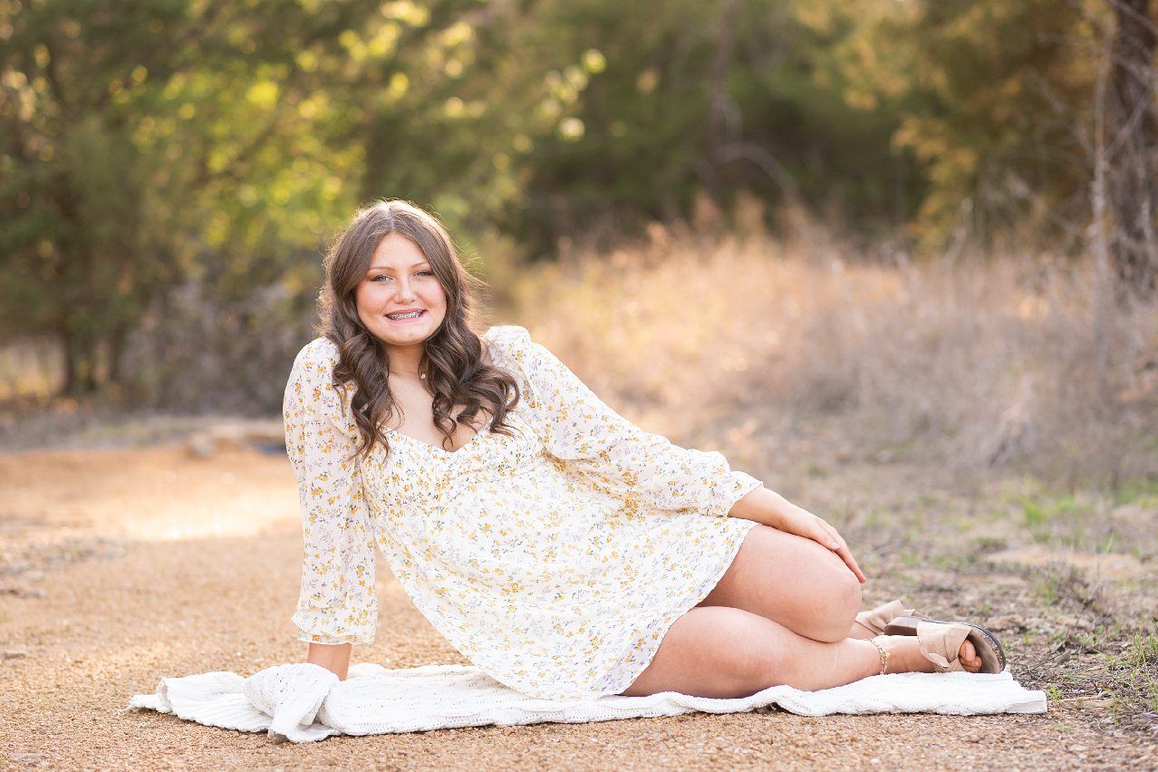 Senior Girl in Spring Field and Cap and Gown by Bartlesville Photographer Kristi Bray