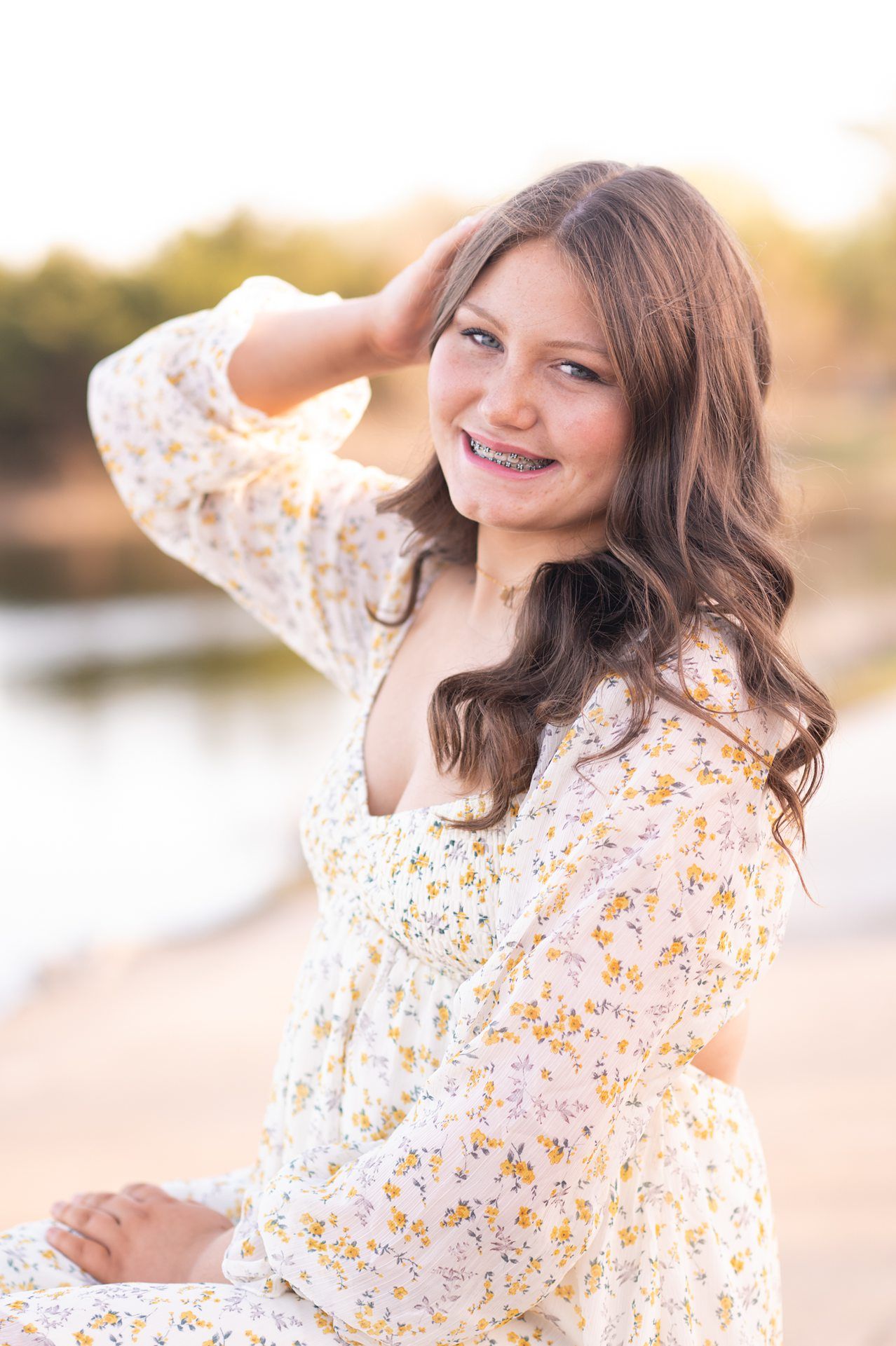 Senior Girl in Spring Field and Cap and Gown by Bartlesville Photographer Kristi Bray