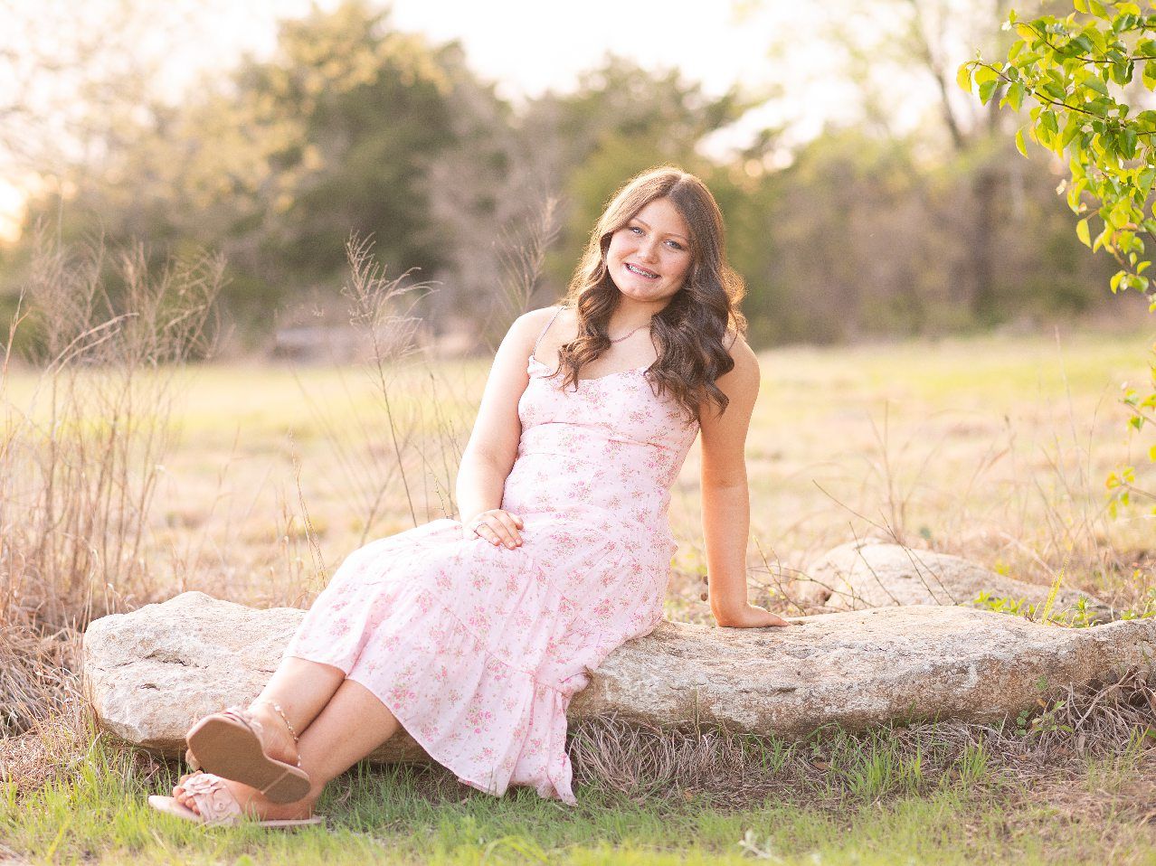 Senior Girl in Spring Field and Cap and Gown by Bartlesville Photographer Kristi Bray
