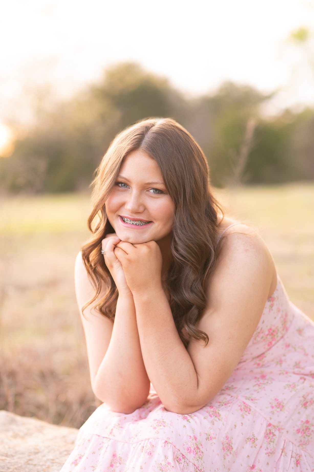 Senior Girl in Spring Field and Cap and Gown by Bartlesville Photographer Kristi Bray