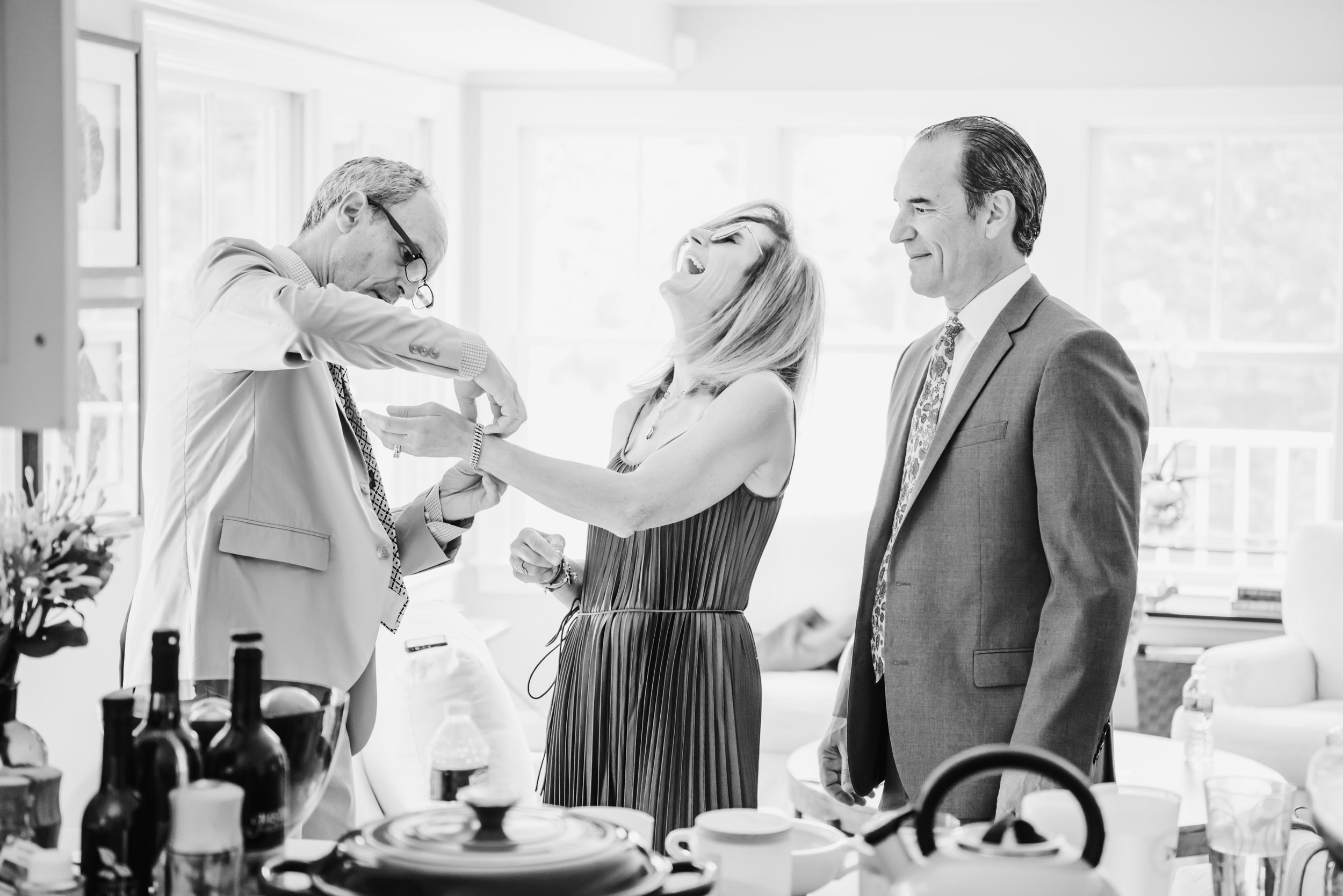 A candid black and white photo of guests enjoying themselves at a celebration.