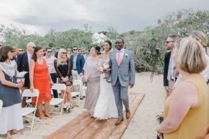 Wedding ceremony on a wooden deck overlooking scenic desert landscape.