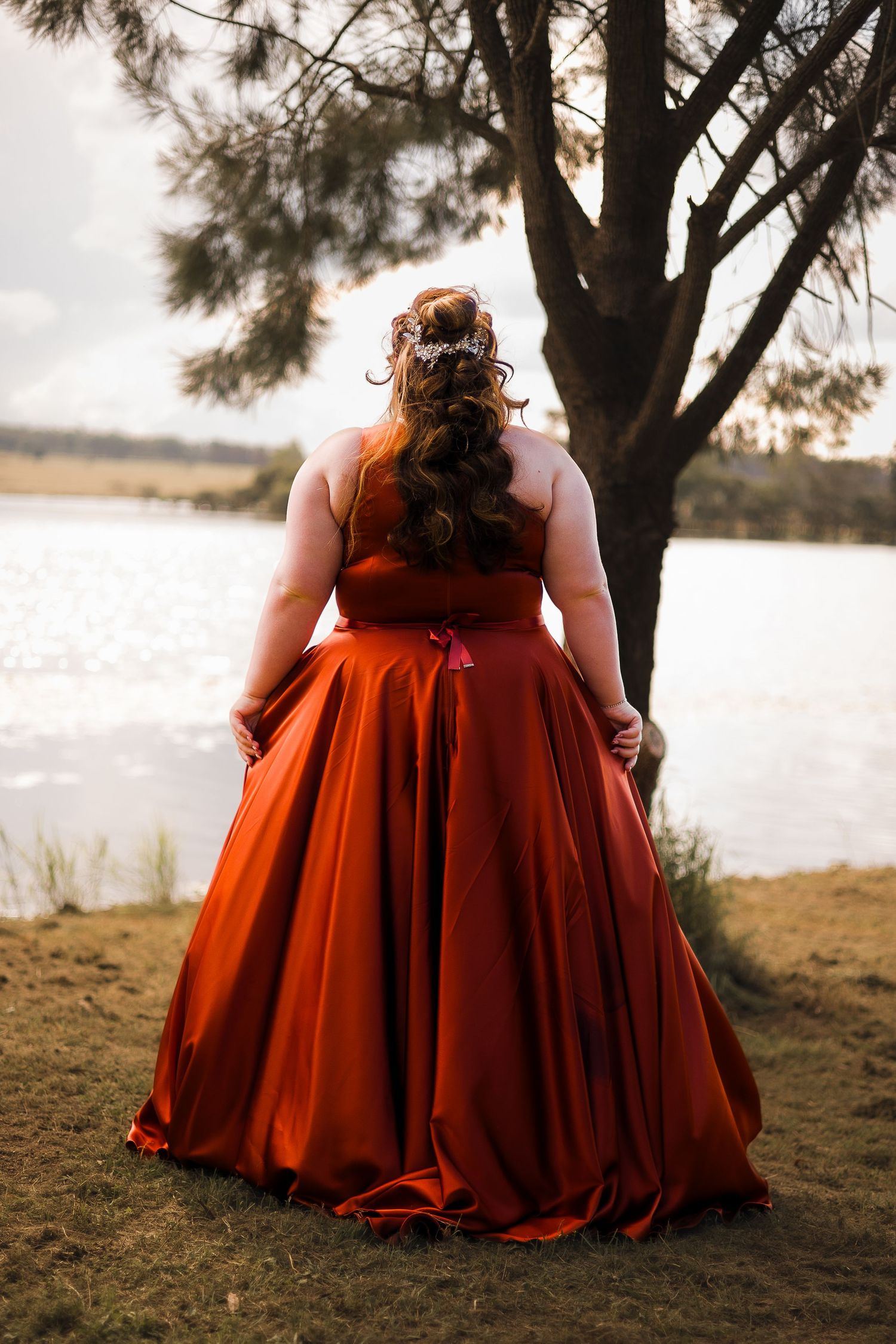 Formal photoshoot at Kingaroy Dam in South Burnett, featuring a person in an elegant formal dress by the serene waters