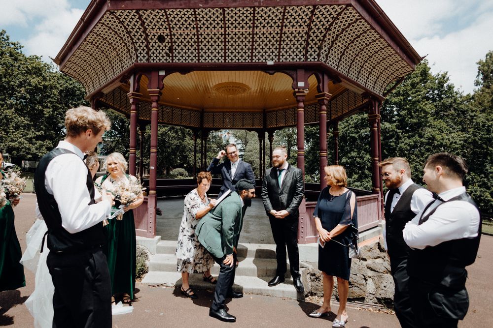 The signing of the marriage contract in a playful way, captured by Apertured Media Auckland Wedding Photographer.