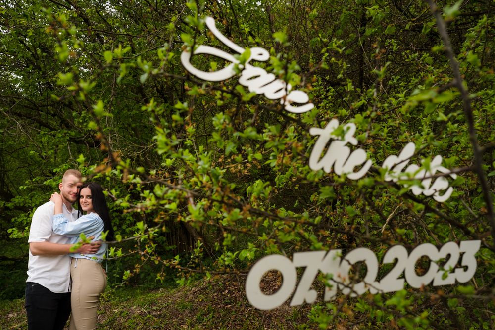 White decorative text displays a date against a green natural background.
