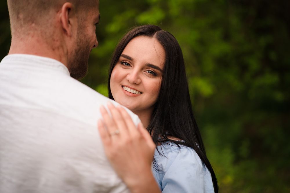 A couple shares a joyful moment together during an outdoor photo session.