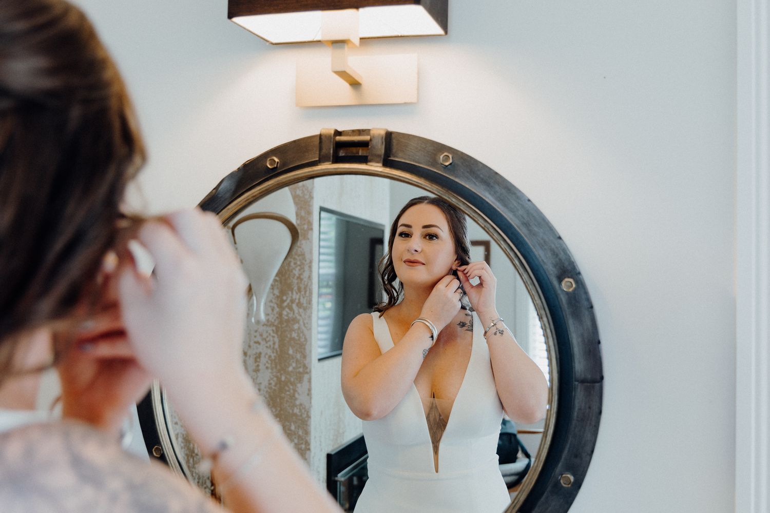 Bride getting ready putting on earrings, captured by Apertured Media Auckland Wedding Photographer.