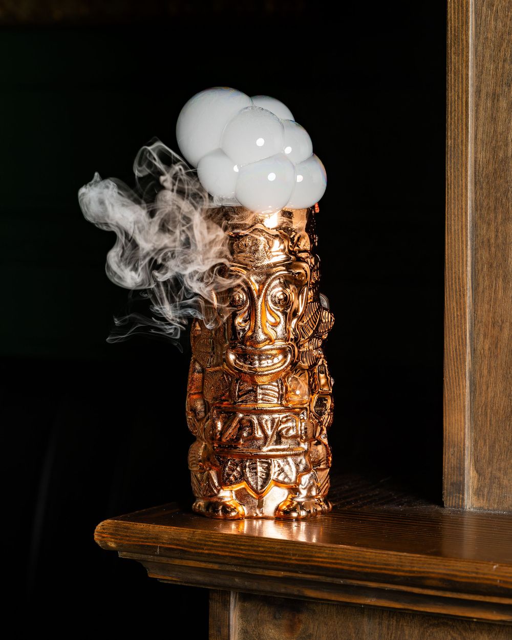 A burning candle with smoke rising creates a warm glow against a dark background in a series of sequential images.
