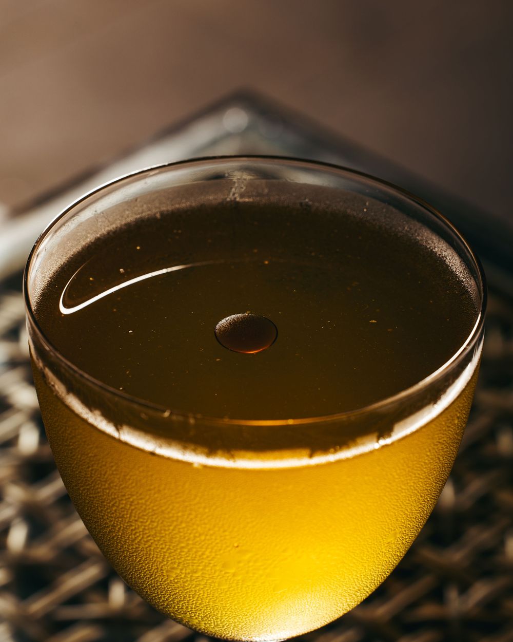 A series of macro shots showing golden liquid in a glass vessel with varying depths and angles of view.