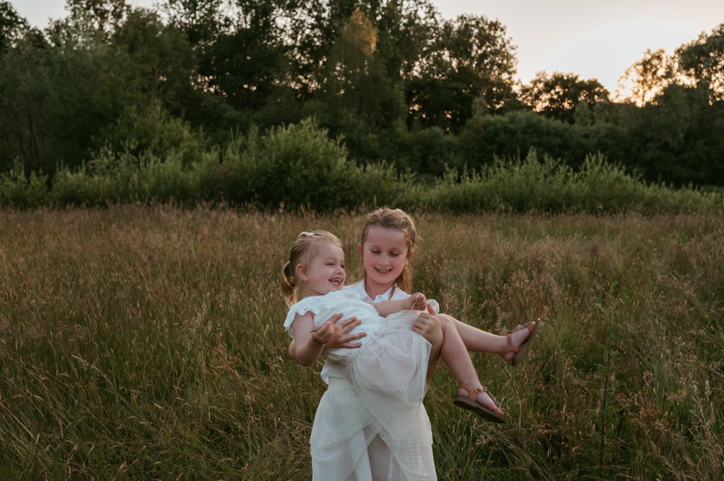 Melissa Stuer Photography Moederschapsfotograaf Moerbeke Oost-Vlaanderen gezin twee zussen natuur zonsondergang kinderen