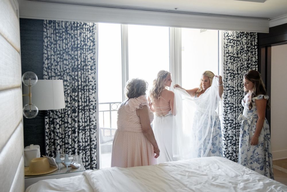 Wedding preparation scene with elegant drapes and natural lighting in a hotel room.