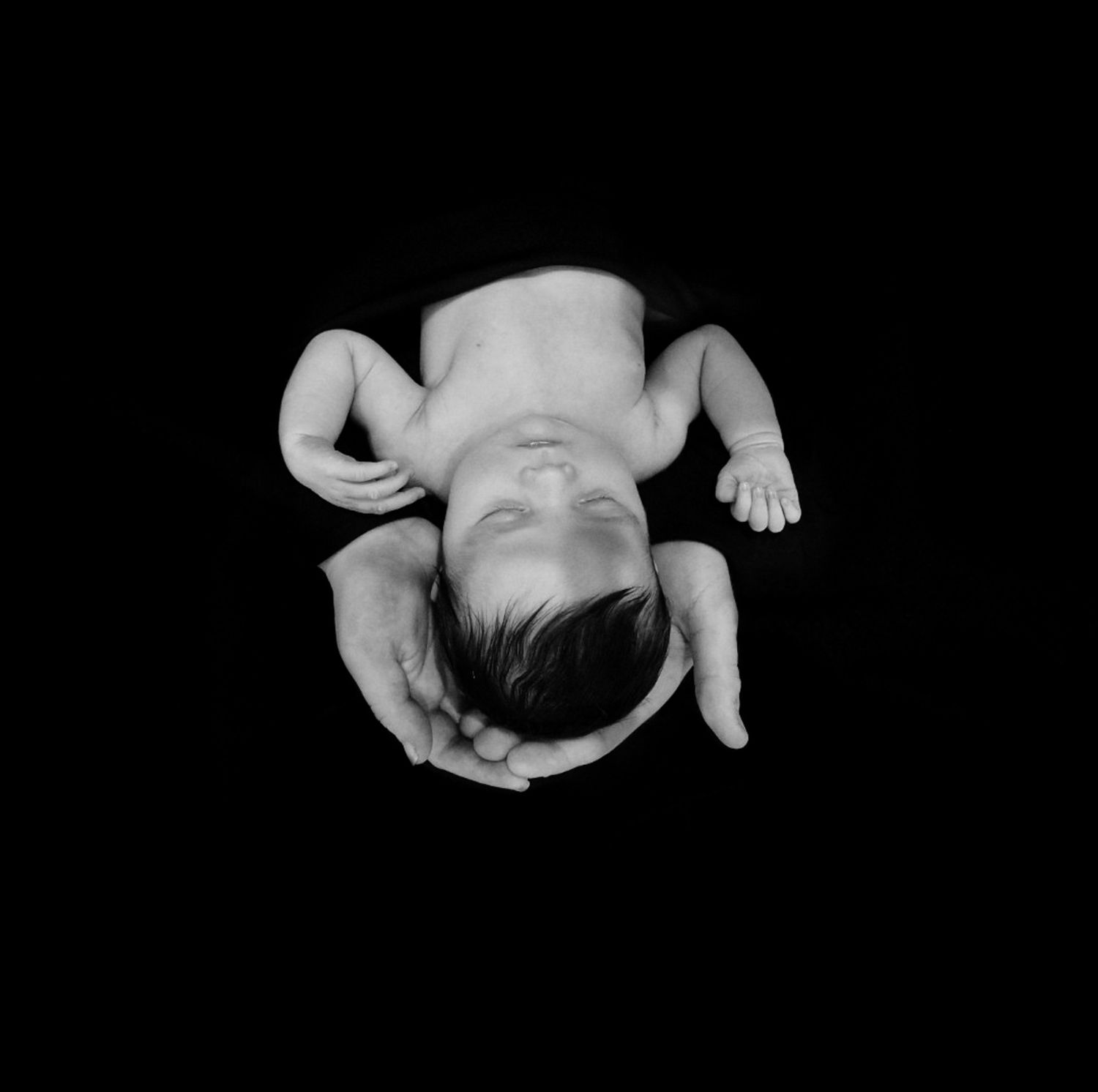 Artistic black and white newborn photography series on dark background.