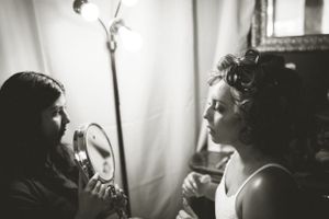 A black and white intimate photograph of two people having a conversation in soft lighting.