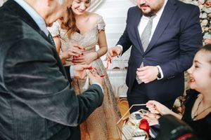 Guests share an entertaining moment during a celebration with animated expressions and gestures.