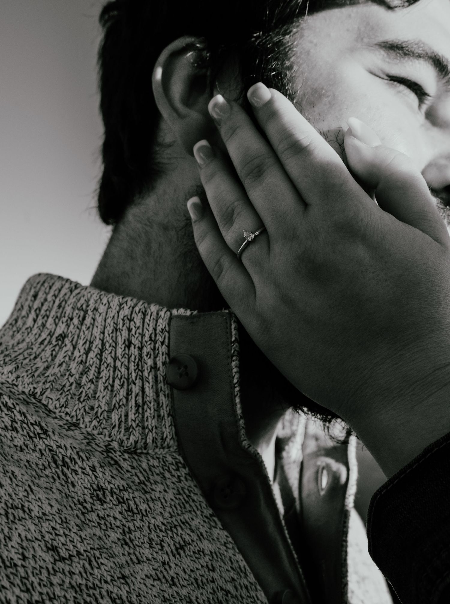 Artistic black and white close-up sequence showing a sparkling engagement ring on her fiancé's face.