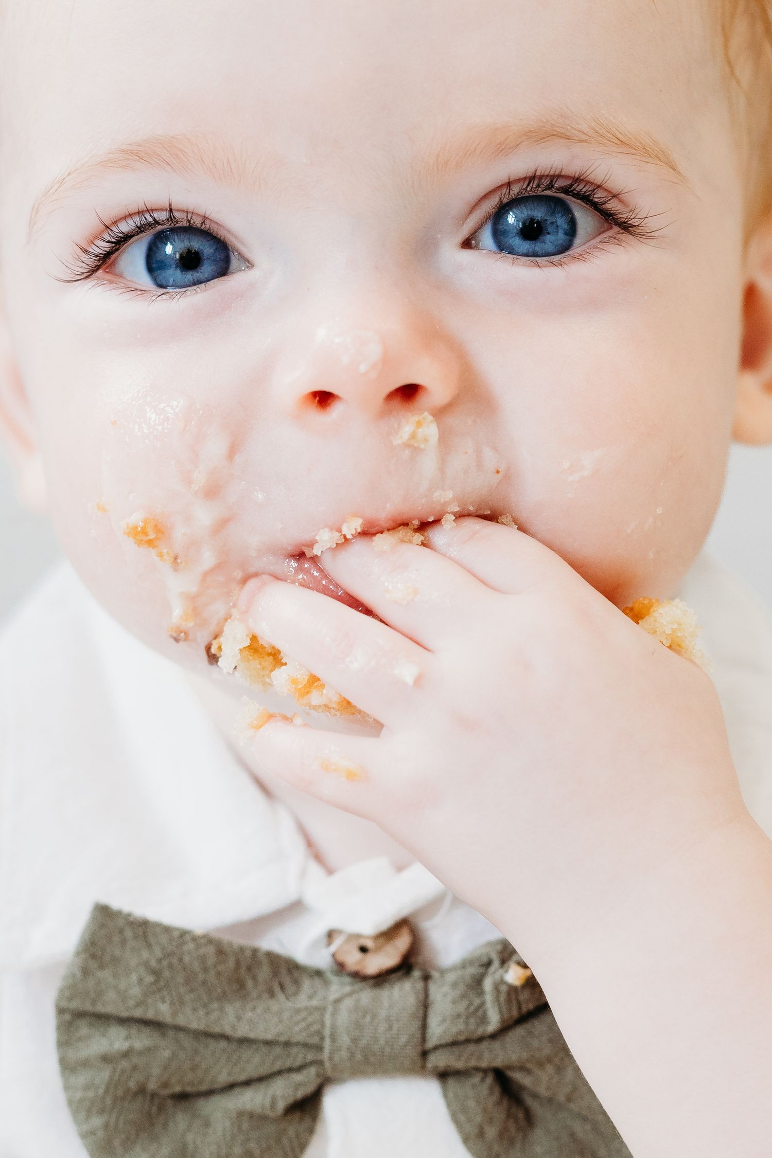 Toddler milestone and cake smash session in Nottingham photography studio, playful smiles and laughter captured by Mapperley photographer.