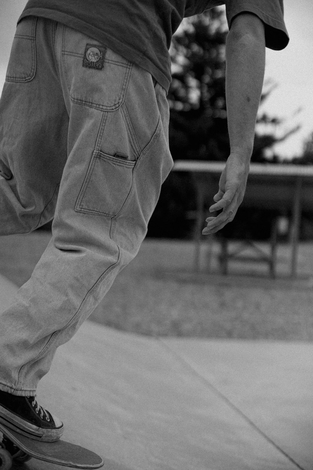 Close-up black and white sequence showing feet performing skateboarding tricks on pavement.