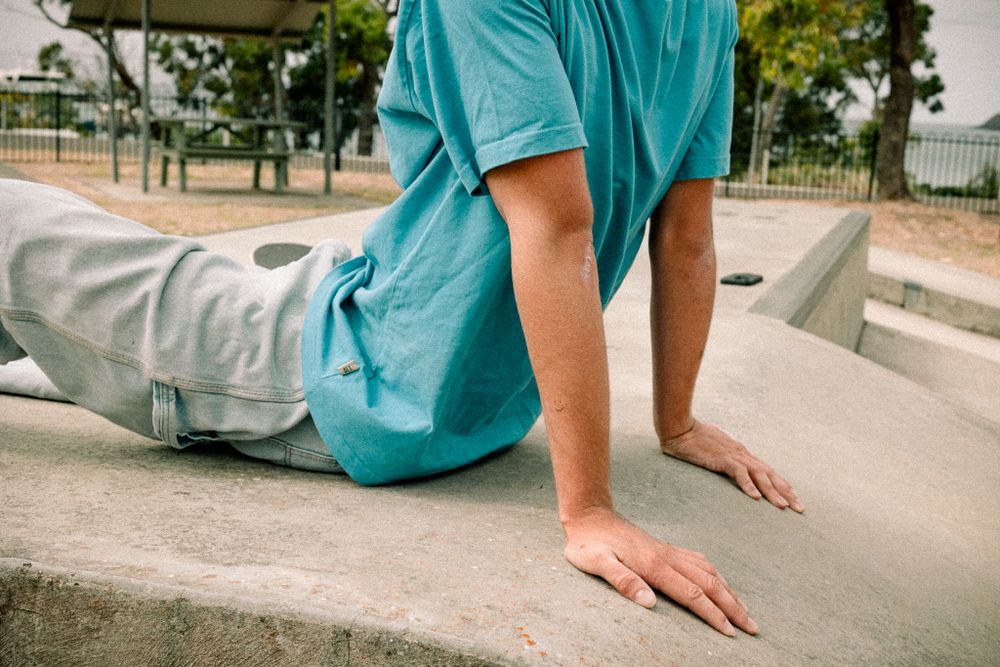 Skateboarding sequence showing turquoise shirt and concrete ramp maneuvers.