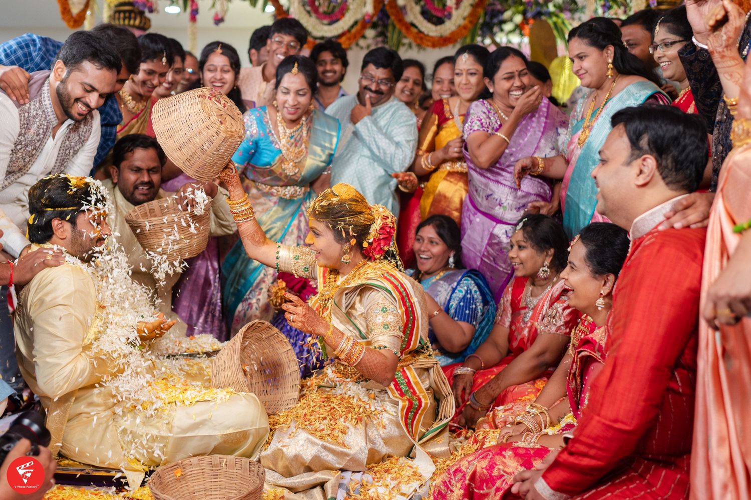Traditional Indian ceremony with guests wearing colorful saris celebrating during a vibrant cultural celebration.