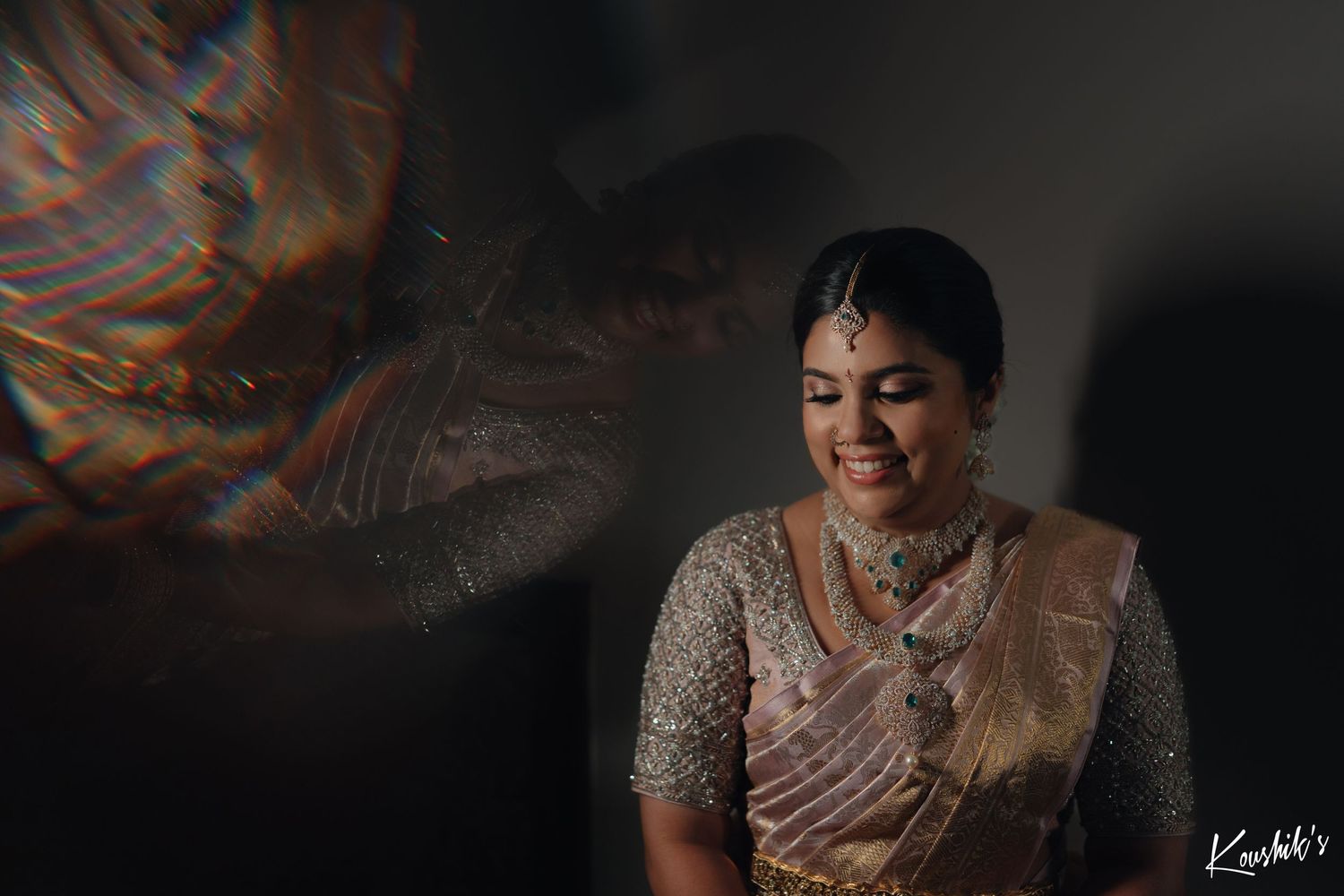 A blurred orange light effect and shadow creates a dramatic mood for a person wearing traditional South Asian attire.