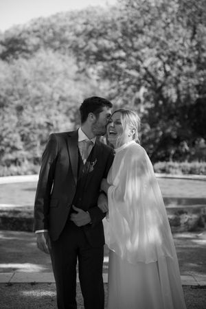 Black and white photo sequence showing tender moments during a wedding ceremony in an outdoor garden setting.