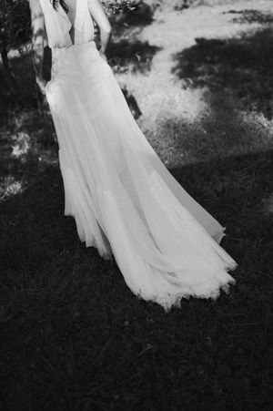 A flowing white wedding dress captured in motion against a dark background.