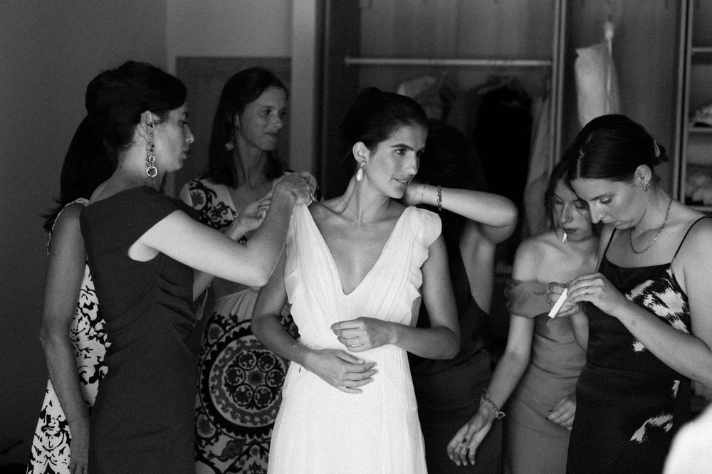Wedding guests dance together at an indoor reception celebration.