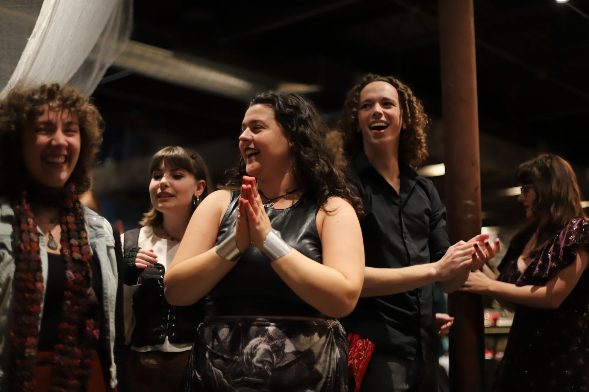 Group of performers react emotionally during theatrical performance scene.