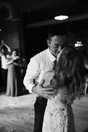 An intimate black and white moment of newlyweds dancing together at their reception.