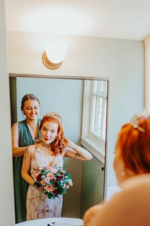 Getting ready scene with crescent moon decor showing final bridal preparations in front of a mirror.
