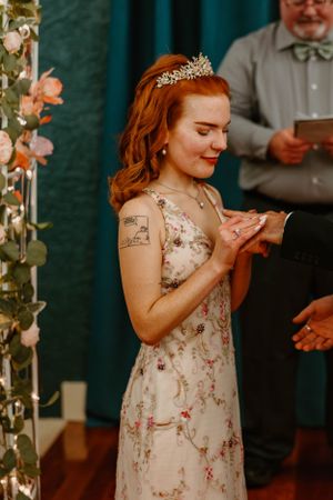 Special wedding ceremony moment captured with delicate floral arch and romantic lighting.