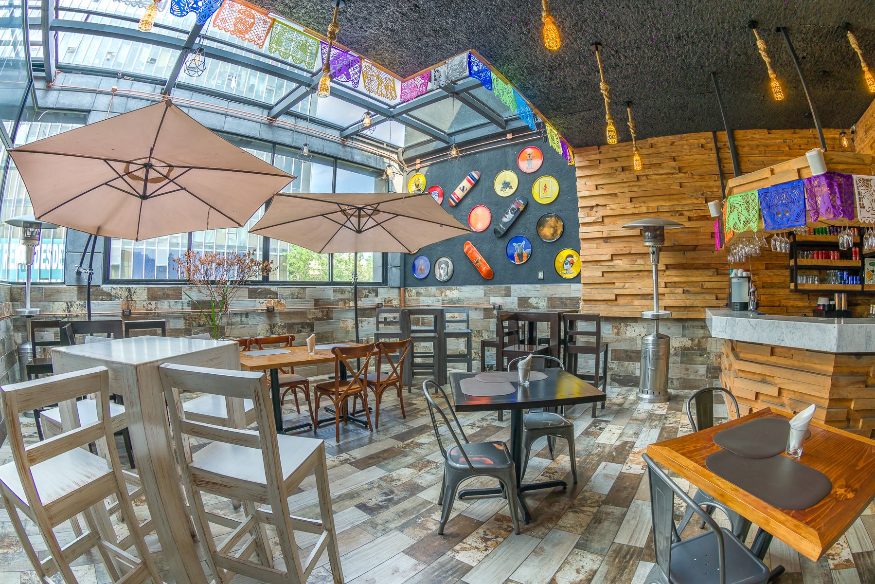 Industrial-style cafe interior with wooden furniture and eclectic wall decorations. Cadillac Hotel Boutique.