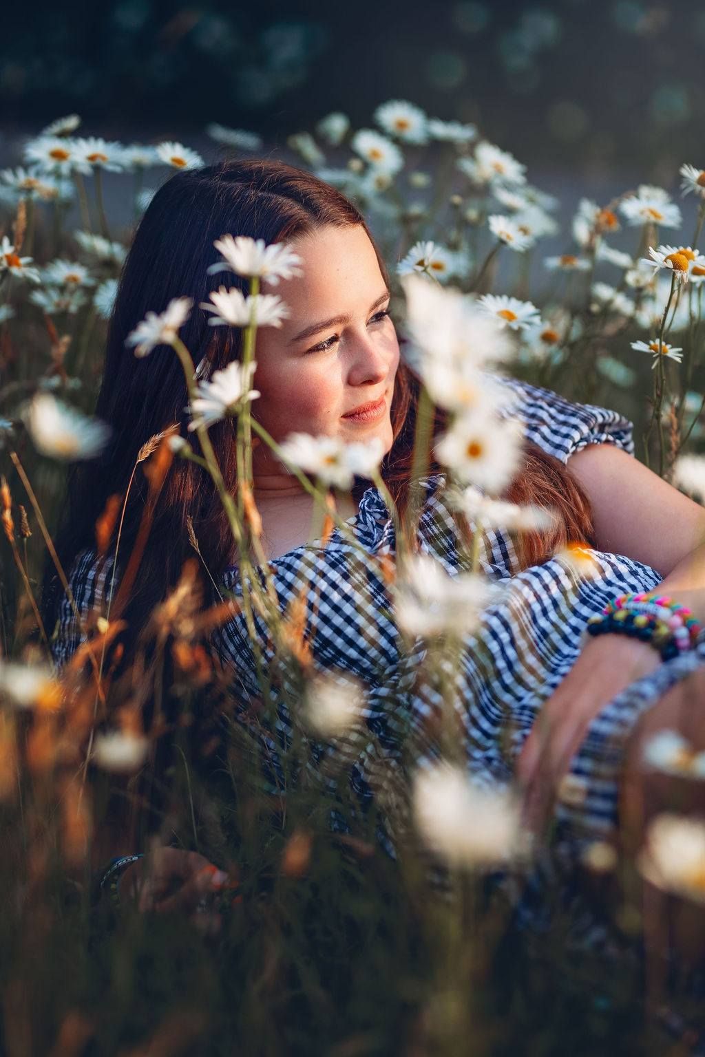 Girl laying in daisies at Neck Point Park, Nanaimo