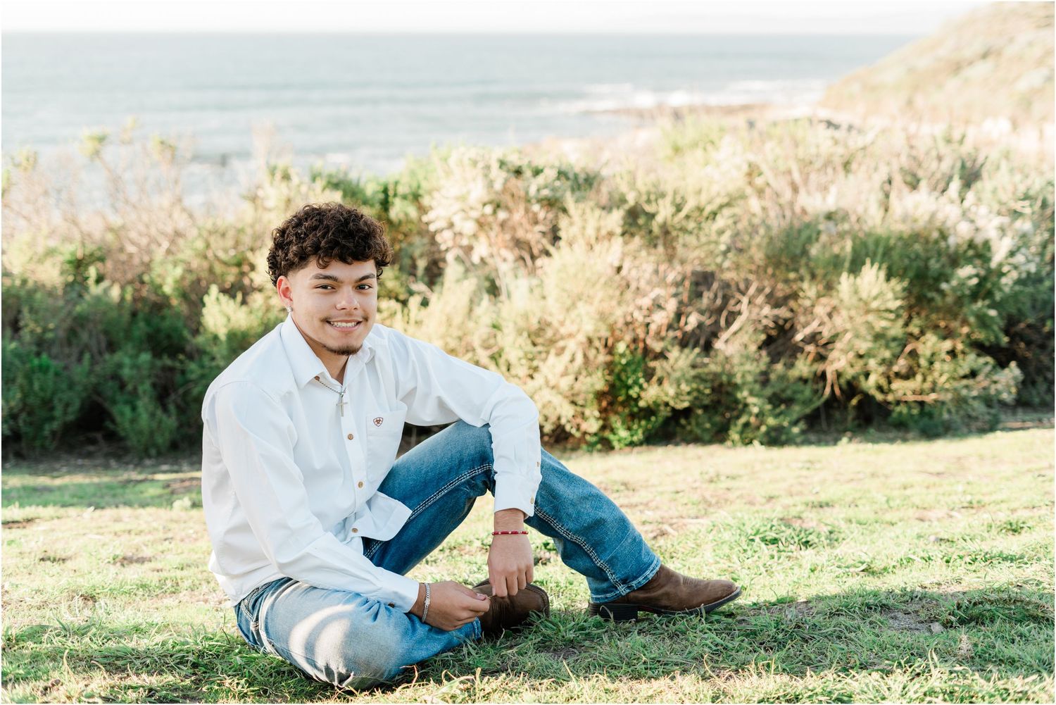 Senior guy photos in Montana de Oro featuring rugged cliffs and scenic coastline by a SLO High senior photographer.
