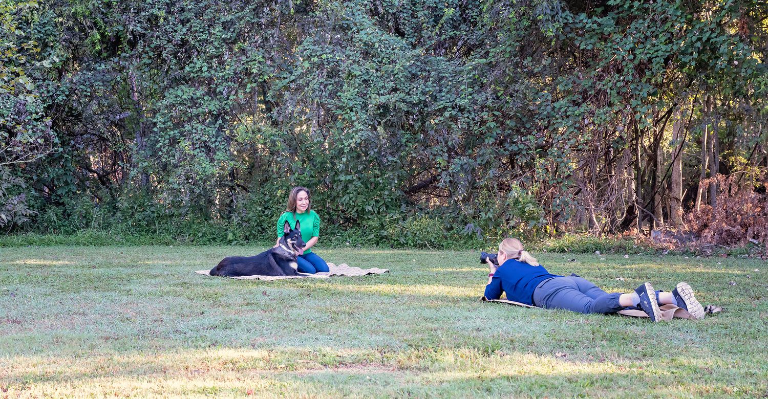 Houston pet photographer Kelly J. Russo photographing a dog at eye level during an outdoor session