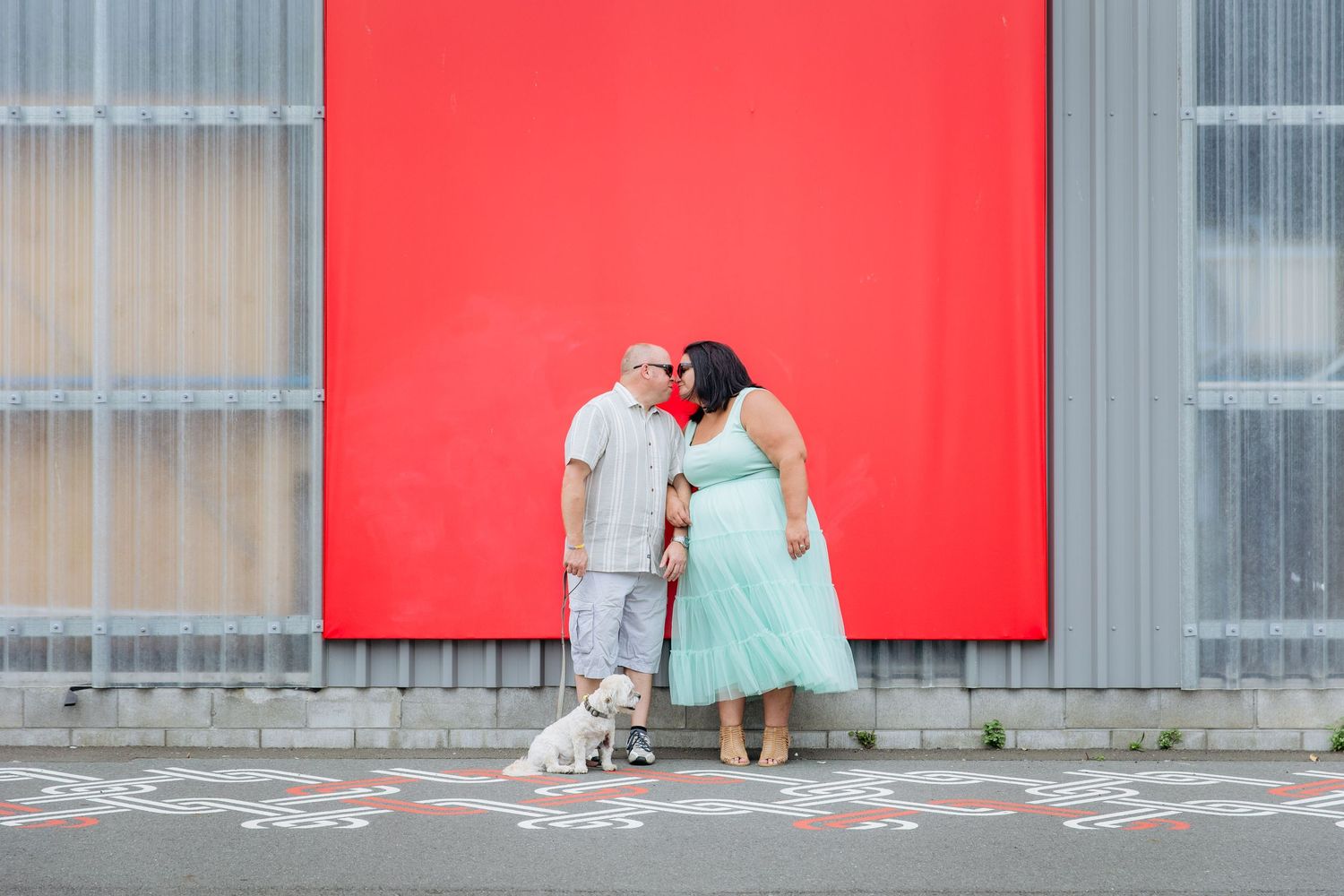 Couple with dog during engagement shoot in urban location