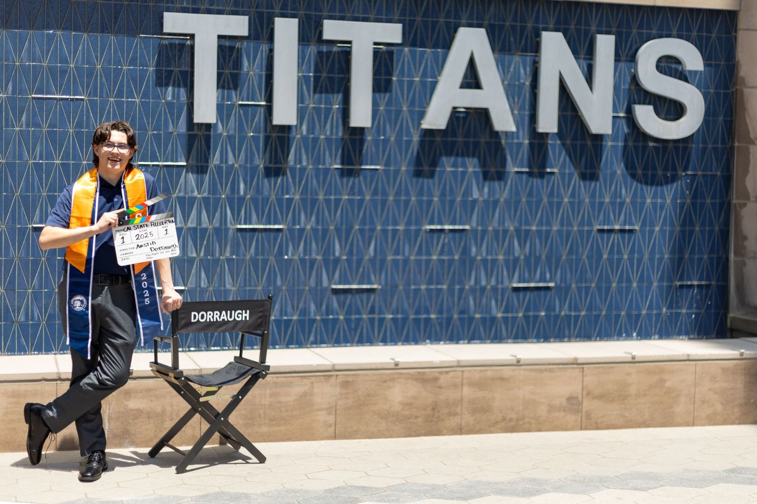 Props in the session and the words Titans in the background. A fun pose during Cal State Fullerton session.