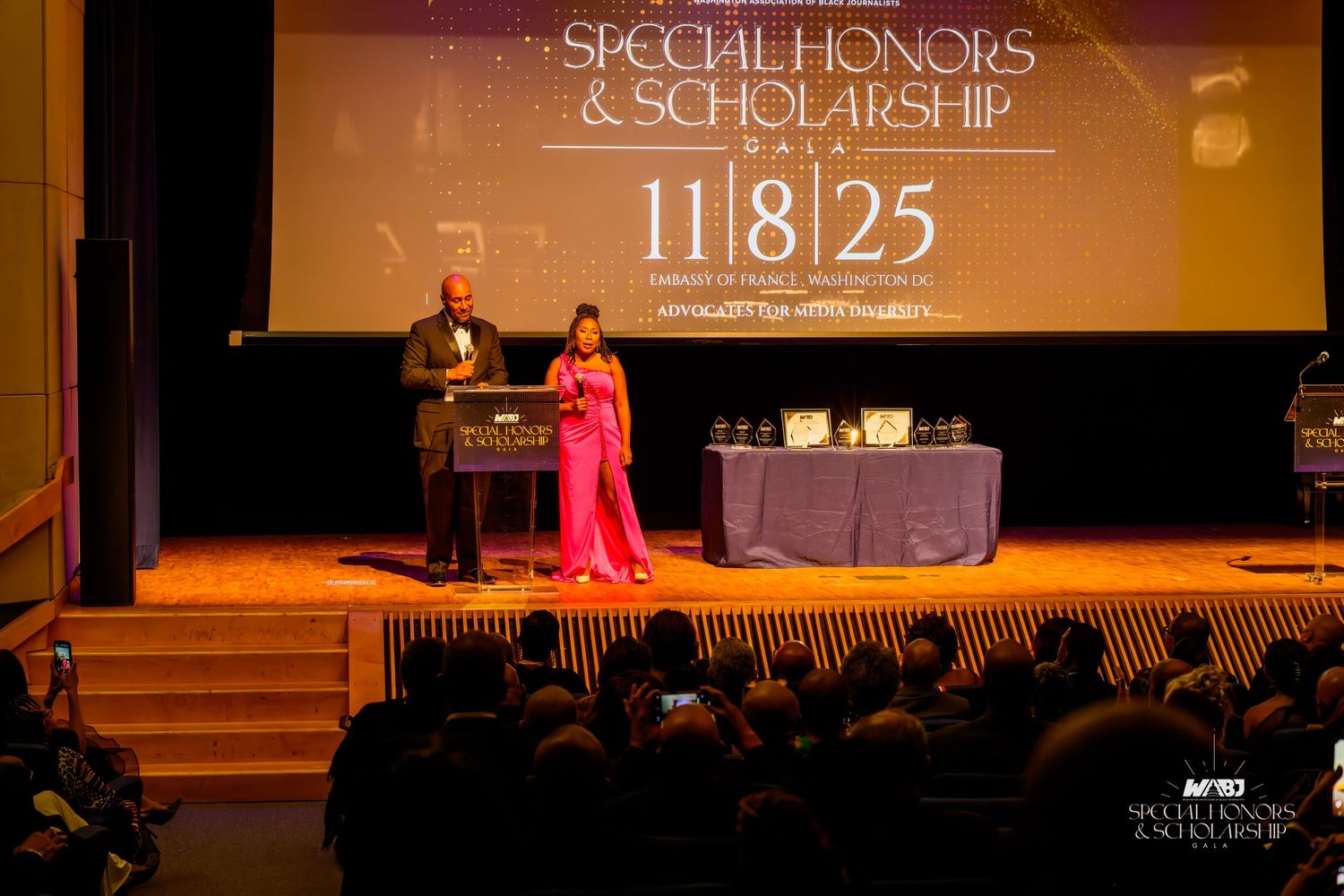 Two presenters on stage at a Special Honors & Scholarship Gala event on November 8, 2025.