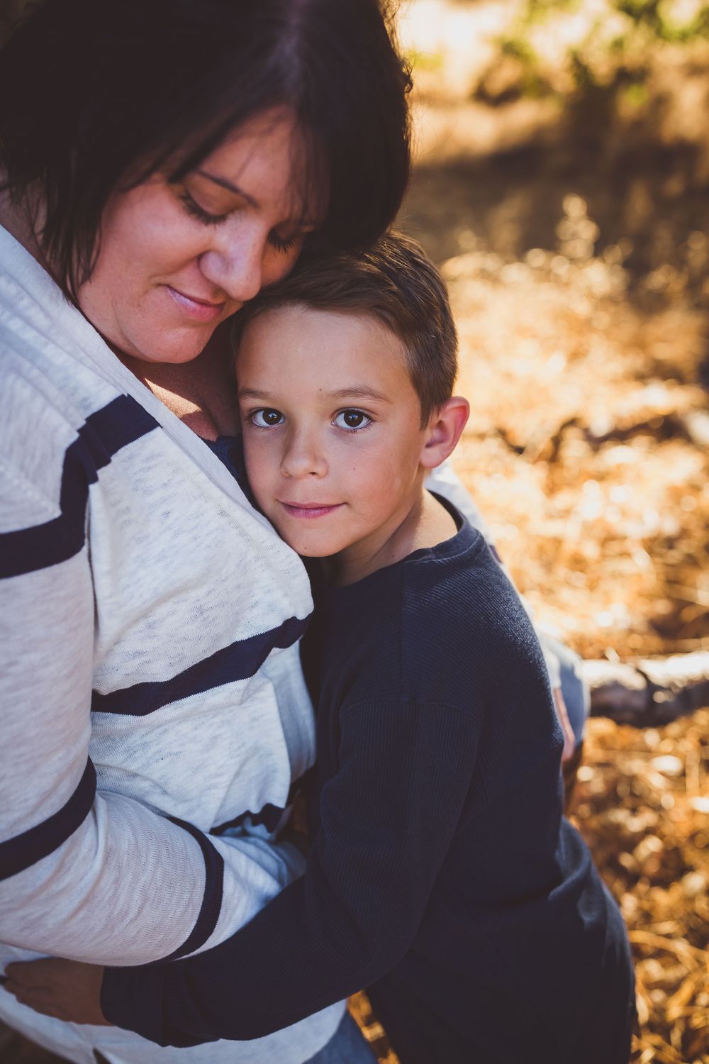 a mom and her son hugging during their yearly fall photos with heidi grace photos in yucaipa ca