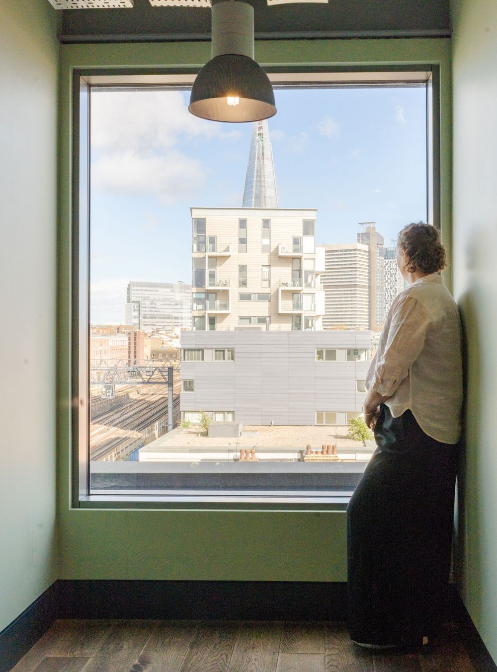 Editorial style branding photo of a woman standing confidently in an urban Kent setting