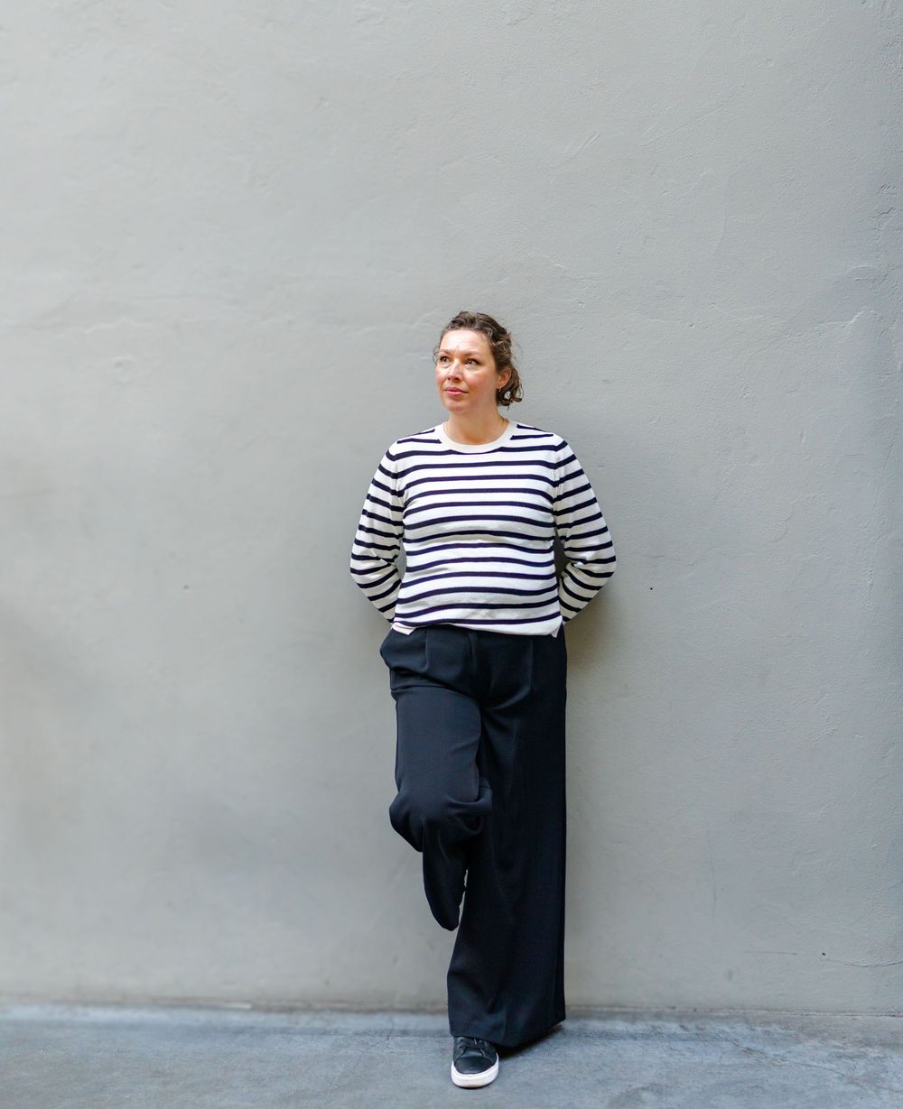 Editorial style branding photo of a woman standing confidently in an urban Kent setting