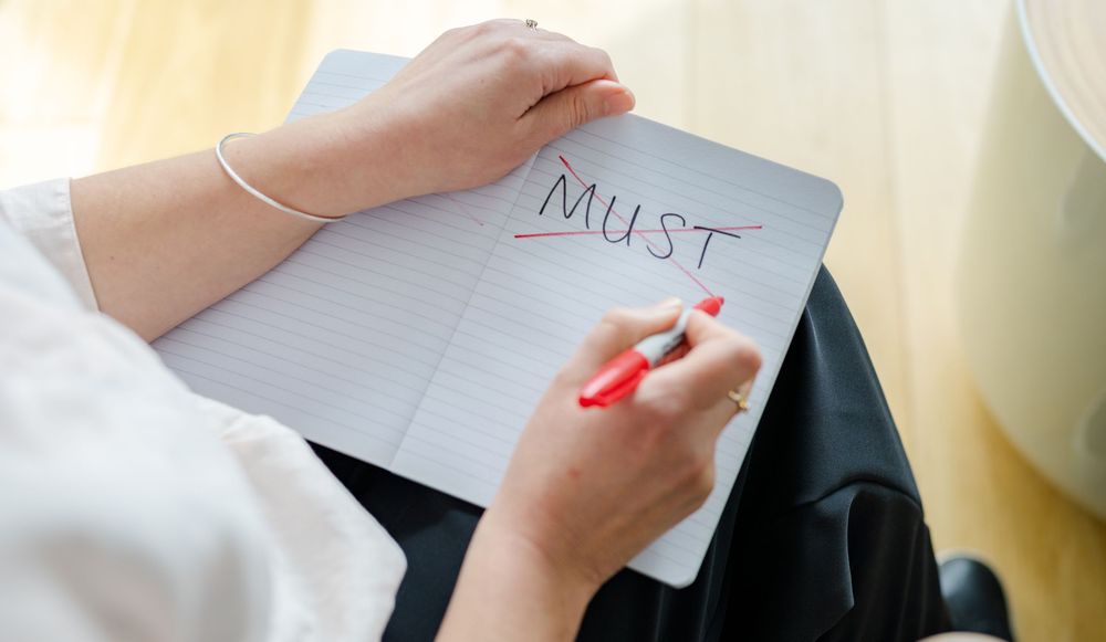 Close-up of hands holding a notebook during a creative branding session in Kent
