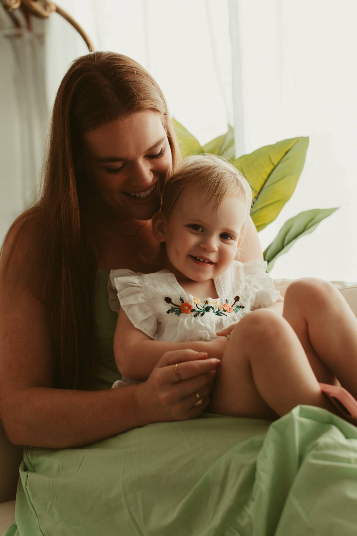 Intimate indoor lifestyle photoshoot with green bedding and natural light.