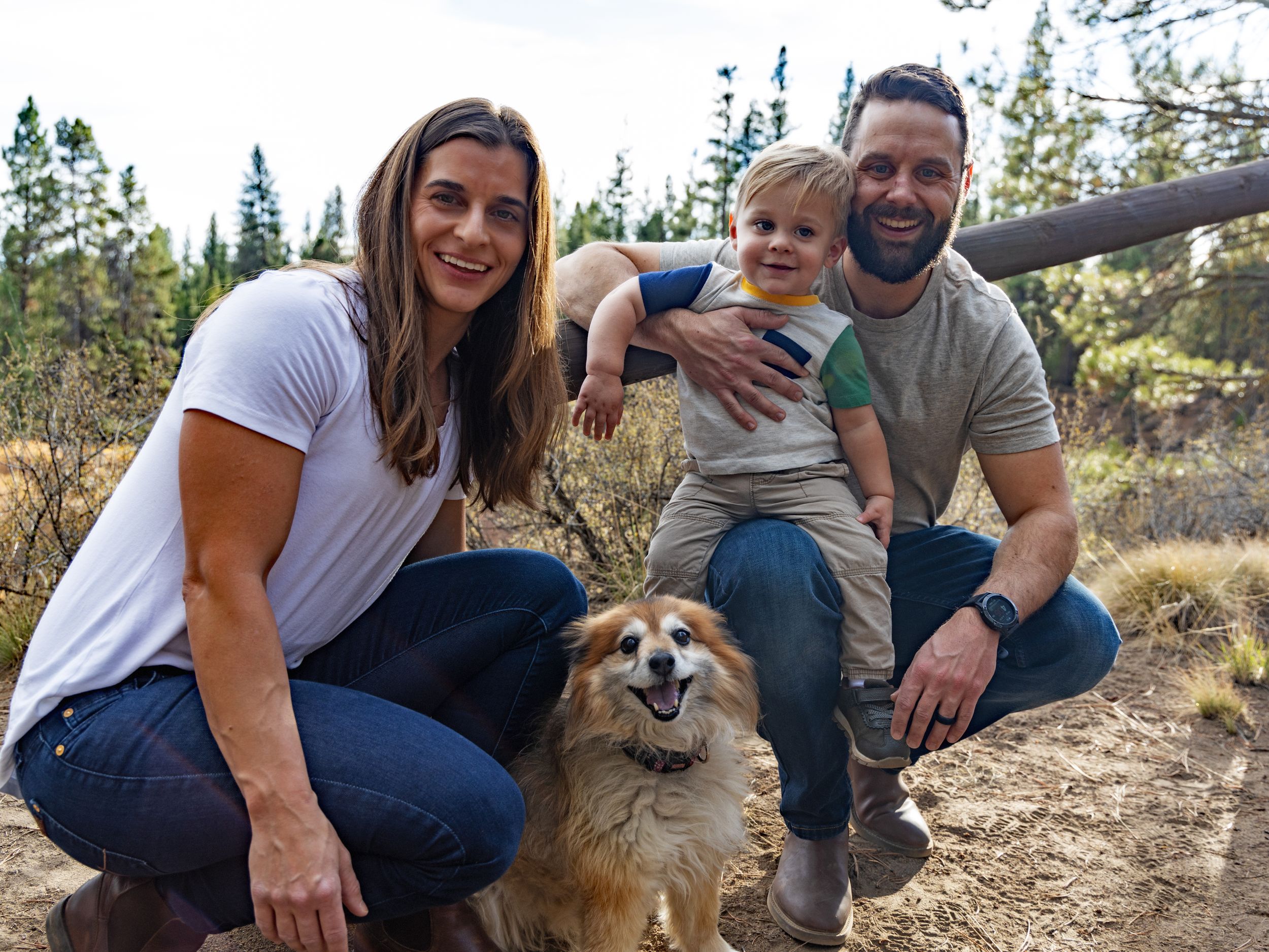 Family photoshoot in nature with a friendly dog joining the group.