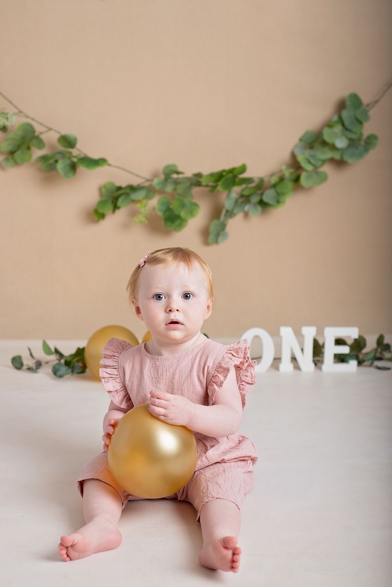 Cake smash or first birthday session. Little girl turning one with eucalypus background. Located in Clarington.
