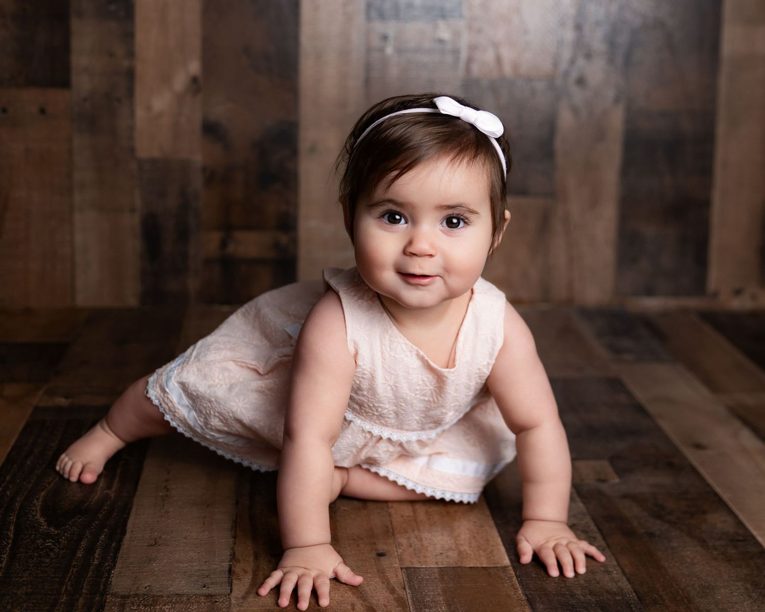 baby girl dressed in lace crawling