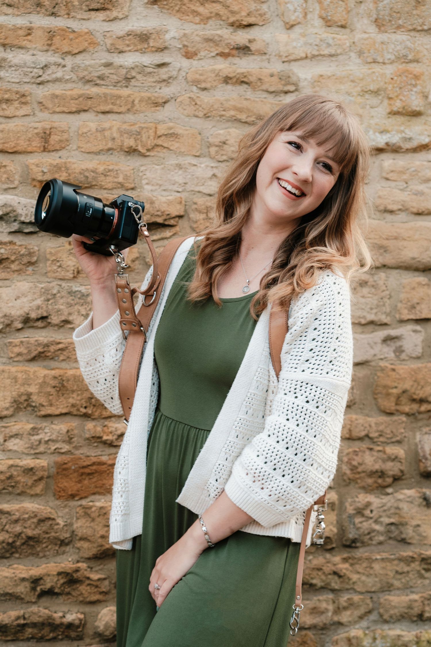 Candid portrait of Lisa from Pausing Time Photography in a wildflower meadow with yellow buttercups in Lower Slaughter Cheltenham