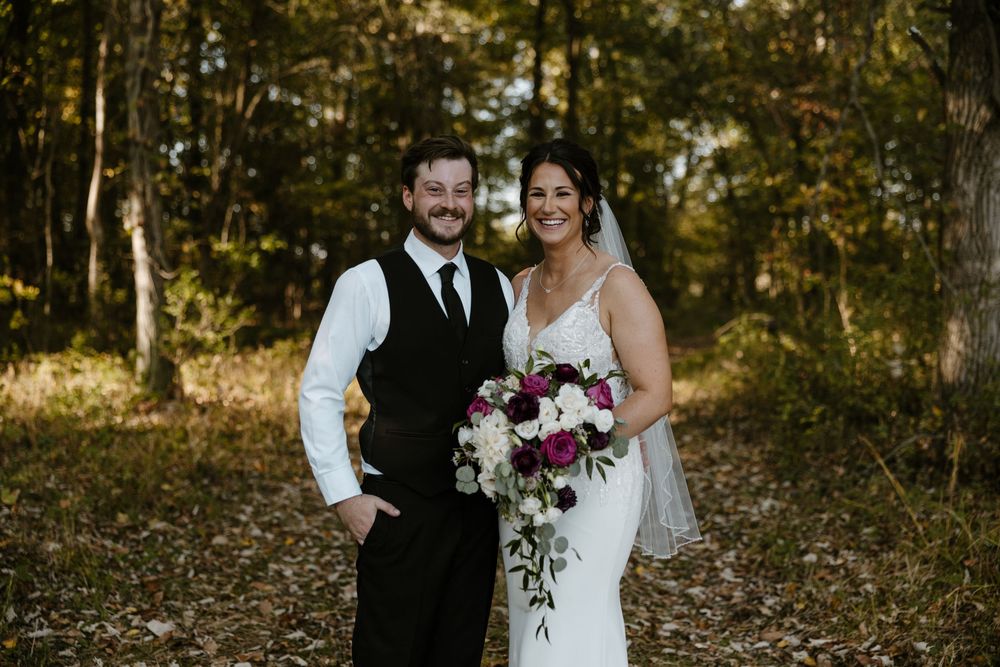 A bride and groom stand together in a lush, wooded setting on their wedding day. Fort Worth Texas wedding photographer.
