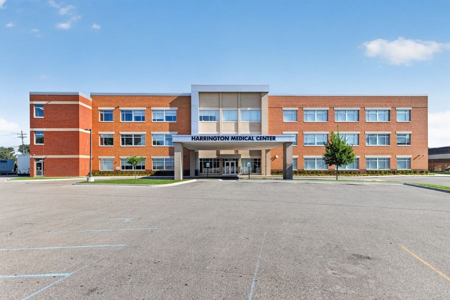 Harrington Medical Center, a large brick building with a modern entrance and expansive parking lot.